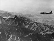 Asisbiz Boeing B-29 Superfortresses 20AF 40BG fly over mountains during a mission to Anshan Japan FRE12001