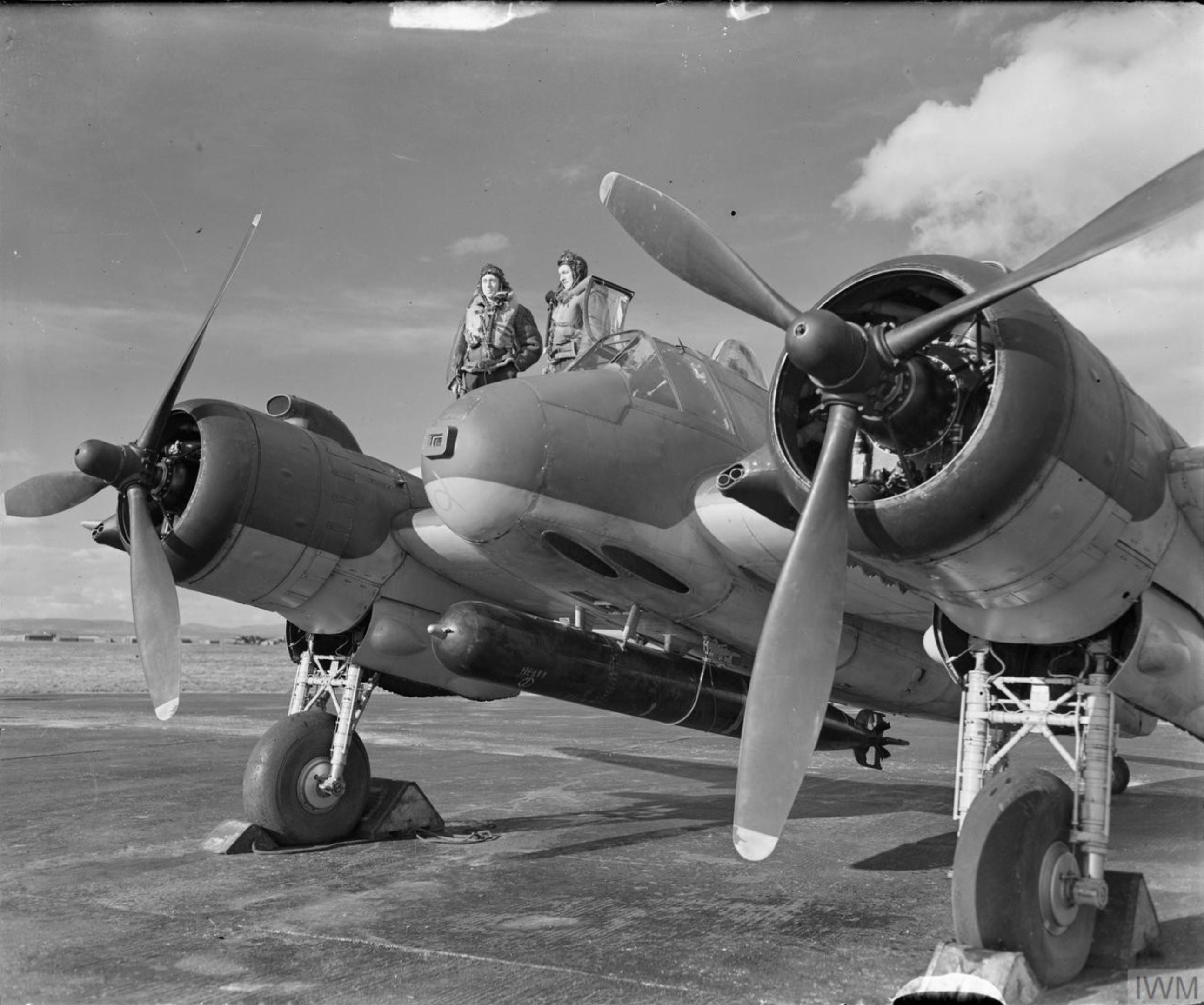 Beaufighter VIC (ITF) RAF 144Sqn crew stand by the cockpit of their aircraft at Tain Ross shire IWM CH9765