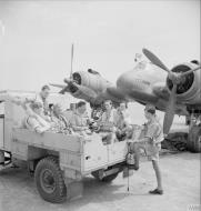 Asisbiz Aircrew RAF 252Sqn climb into the back of a lorry for the drive to their Headquarters at Idku Egypt IWM CM3619