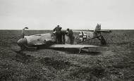 Asisbiz Messerschmitt Bf 109F4 2.JG52 Black 2 belly landed being checked by several Luftwaffe blackmen 01