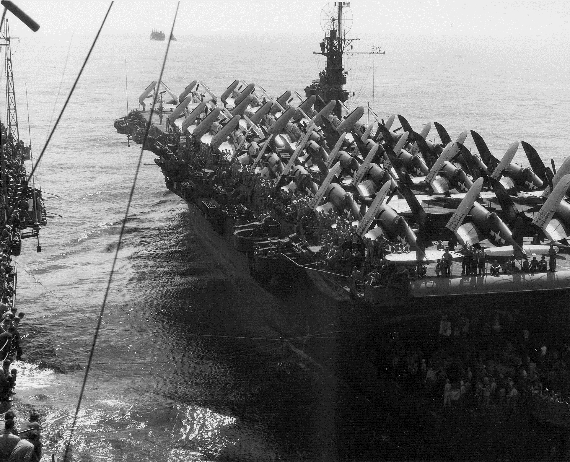 CVE 102 USS Attu during exchange of goods with another ship 3rd Sep 1945 01