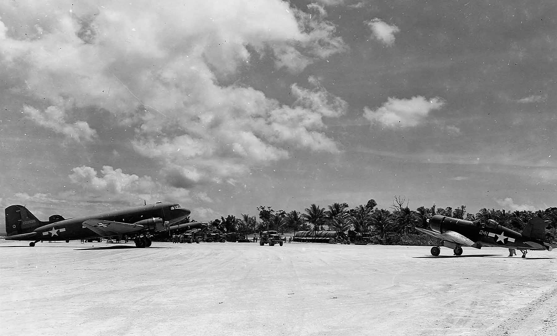 Vought F4U-1A Corsair VMF-223 White 241 sits next to R4D Skytrain 42 23535 on Emirau Island 1945 01