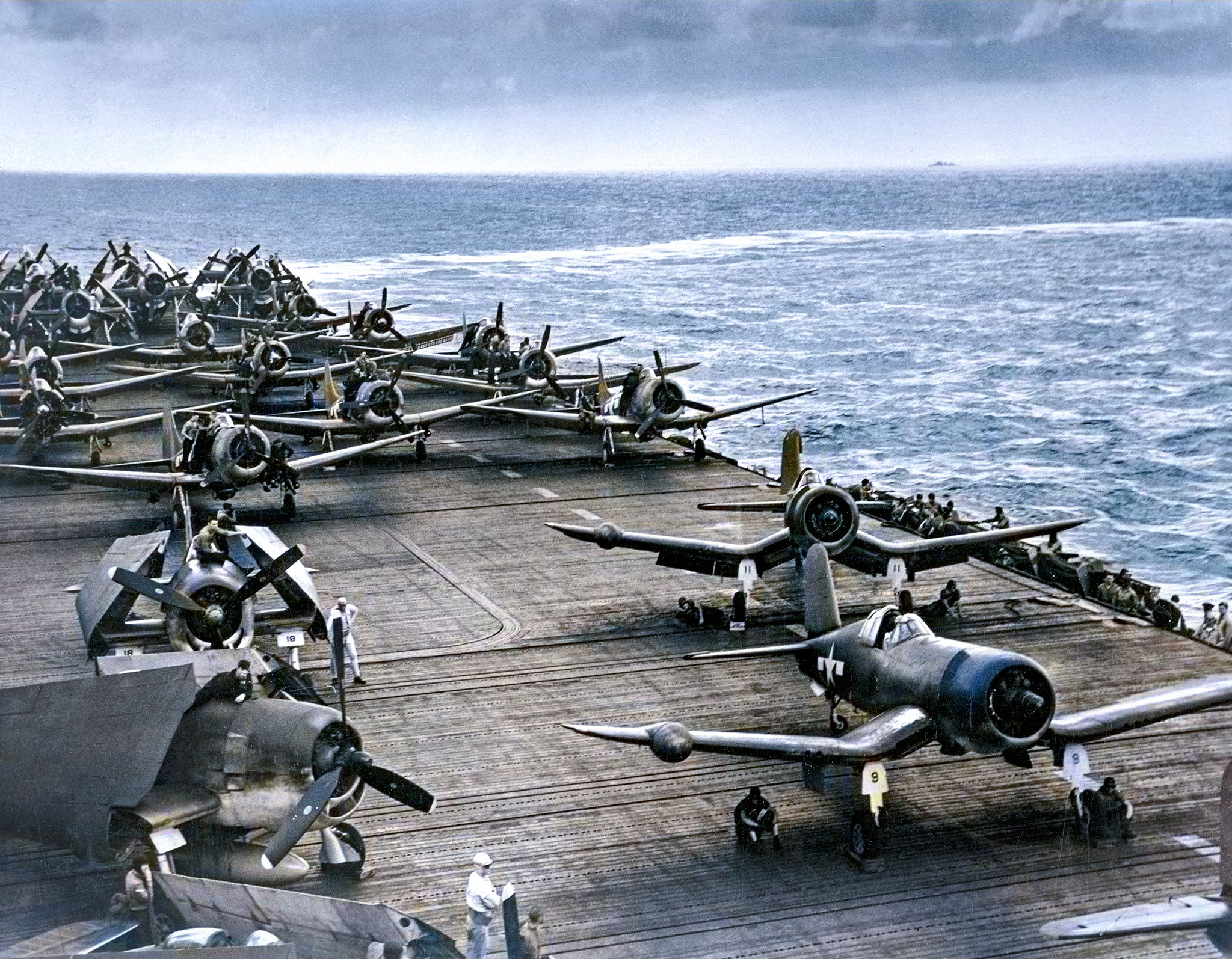 Vought F4U-5N Corsair move up the flight deck for take off on a raid against Truk Feb 1944 01