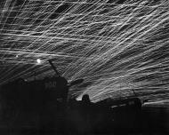 Asisbiz Silhouetted by Anti aircraft tracers Corsairs 302 and 315 Yonton Airfield Okinawa Japan 28th Apr 1945 01