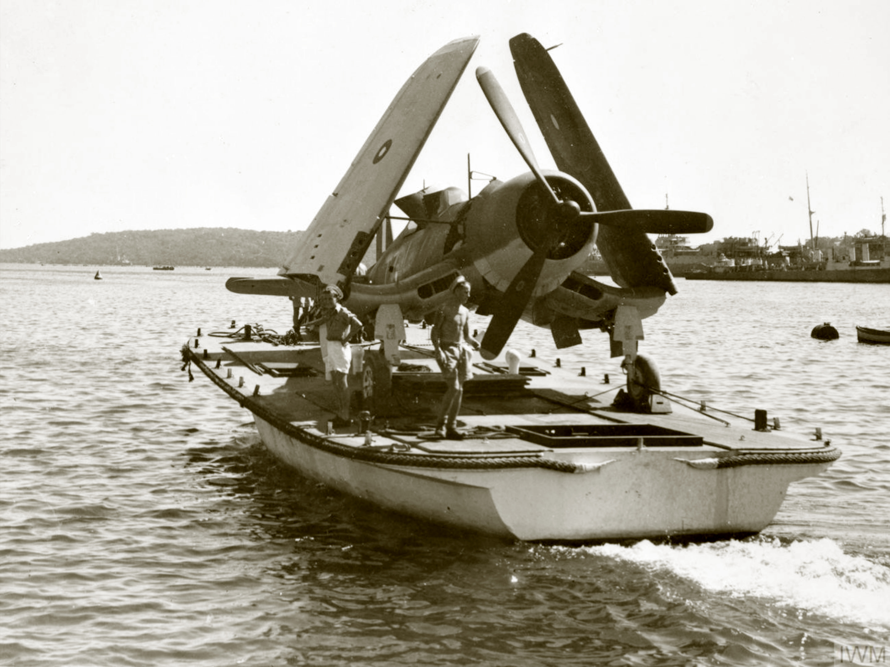 Fleet Air Arm Corsair being ferried back to its carrier after repairs NAS Colombo Mar 1945 IWM A28417