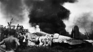 Asisbiz RNZAF Firemen helping a Corsair pilot after crashing off the runway at Bougainville 02