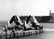 Asisbiz Vought F4U 1A Corsair VF 17 White 38 and 3 being moved ashore 01