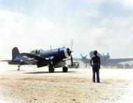 Asisbiz Goodyear FG 1 Corsair VMF 114 BulNo 14513 with a Napalm tank lands on Peleliu Sep 1944 80 G 425532