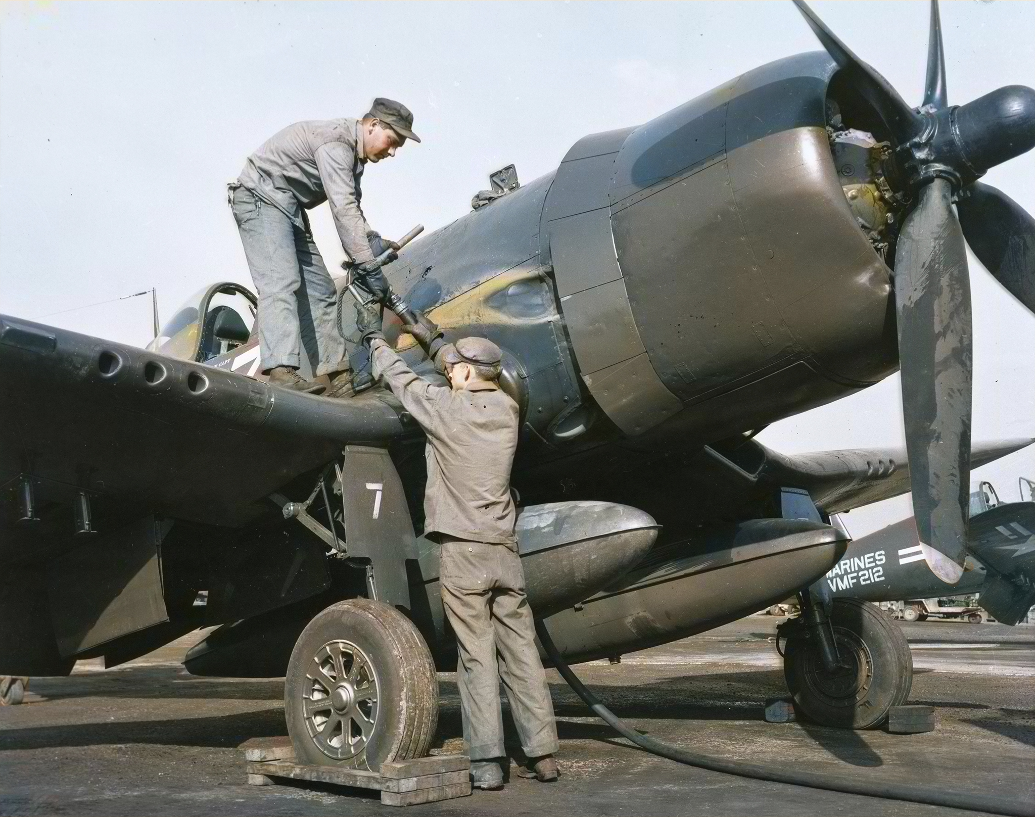 Vought F4U-5 Corsair VMF-212 White LD7 being refueled at a repair center with VMF-212 foreground Kimpo Airfield Korea circa 1950 01
