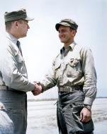 Asisbiz Aircrew VMF 214 Black Sheep pilot based in Korea 1Lt Lyle R Bradley 3rd Air Medal is congratulated by CO LtCol James W Poindexter 01