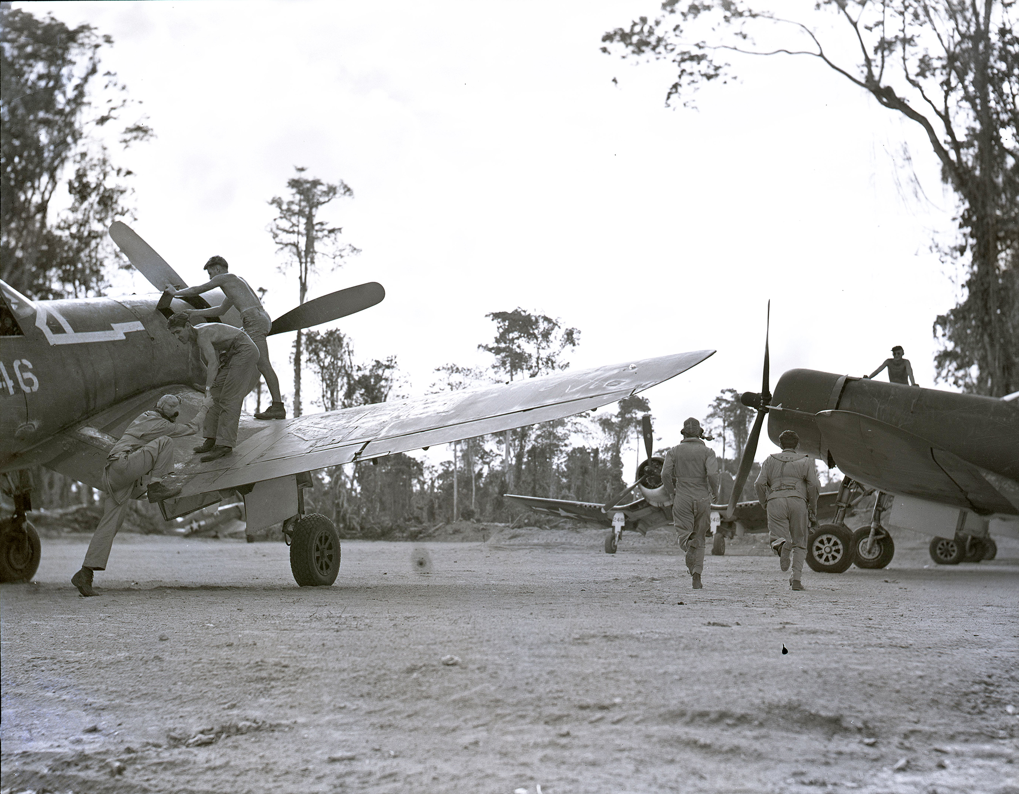 Vought F4U-1A Corsair VMF-222 White 946 as pilots scramble to their planes on Bougainville 14th Feb 1944 NARA