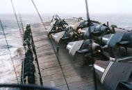 Asisbiz USS Gilbert Islands CVE-107 flight with Grumman TBF Avengers tied down in rough seas typhoon 1945 NNAM 1578
