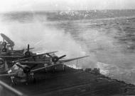 Asisbiz Grumman F6F 5 Hellcats VF 19 lay exposed on deck as CV 16 comes under attack Nov 1944 01