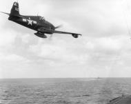 Asisbiz Grumman F6F 5N Hellcat flies past USS Hornet CV 12 as its pilot drops a message during strikes on Formosa Oct 1944 80G284466