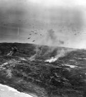 Asisbiz Grumman F6F Hellcat fighters sweep over Iwo Jima's rugged northern area 21st Feb 1945