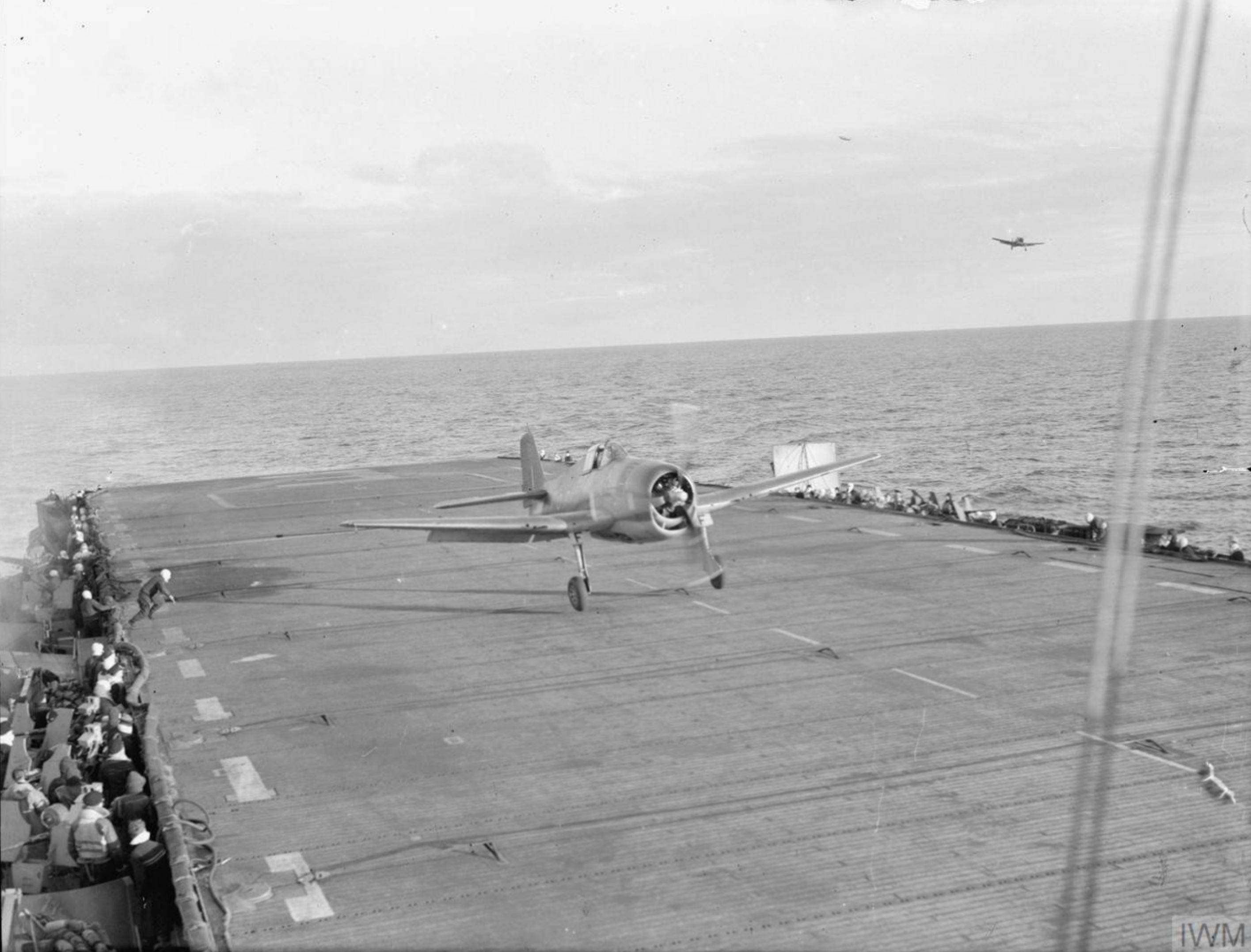 Fleet Air Arm 800NAS or 804NAS Hellcat landing aboard HMS Emperor during Tirpitz strike 3rd Apr 1944 IWM A22655