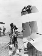 Asisbiz Grumman Hellcat MkII RN FAA 808NAS SubLt RJ Foxley examins his damaged aircraft Colombo May 1945 IWM A28722