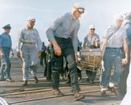 Asisbiz USS Essex (CV 9) F6F Hellcat VF 15 damaged over Wake pilot Lt JJ Collins on a stretcher after crash landing 23rd May 1944