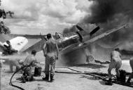 Asisbiz Grumman F6F 5 Hellcat VF 33 on fire at Ondonga Airfield New Georgia 01