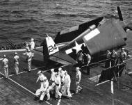 Asisbiz USS Bataan (CVL 29) F6F 5 Hellcat VF 47 sits on the flight deck during a burial ceremony off Okinawa 18th Apr 1945 BW!
