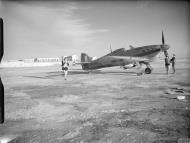 Asisbiz Fleet Air Arm Sea Hurricane BC765 pilot running to his aircraft which stands ready on an airfield in Malta IWM 13426