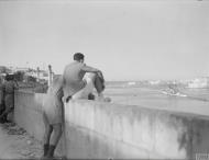 Asisbiz Royal Navy cruiser HMS Welshman followed by HMS Cairo leaving Grand Harbour Malta 16th Jun 1942 IWM A10414