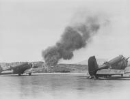 Asisbiz Nordfront Junkers Ju 52 parked at Oslo with a RAF intruder buring bg 15th Apr 1940 NIOD