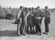Asisbiz Aircrew Luftwaffe SG3 pilots study their maps at Immola for their next mission 2nd Jul 1944 01