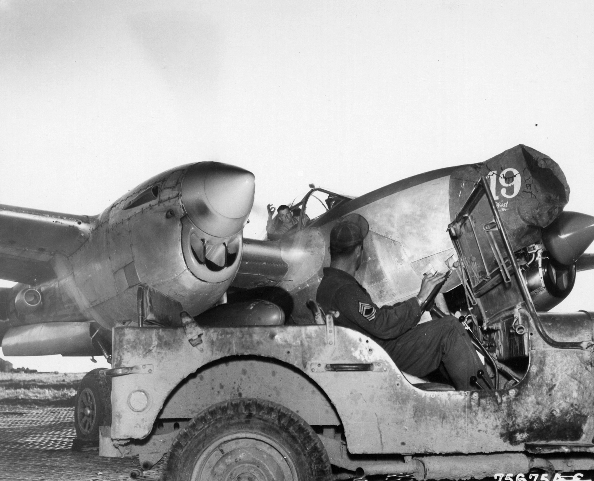 Lockheed P-38 Lightning 15AF 1FG94FS ground crew undergoing maintenance at an airfield somewhere in Italy 1944 01