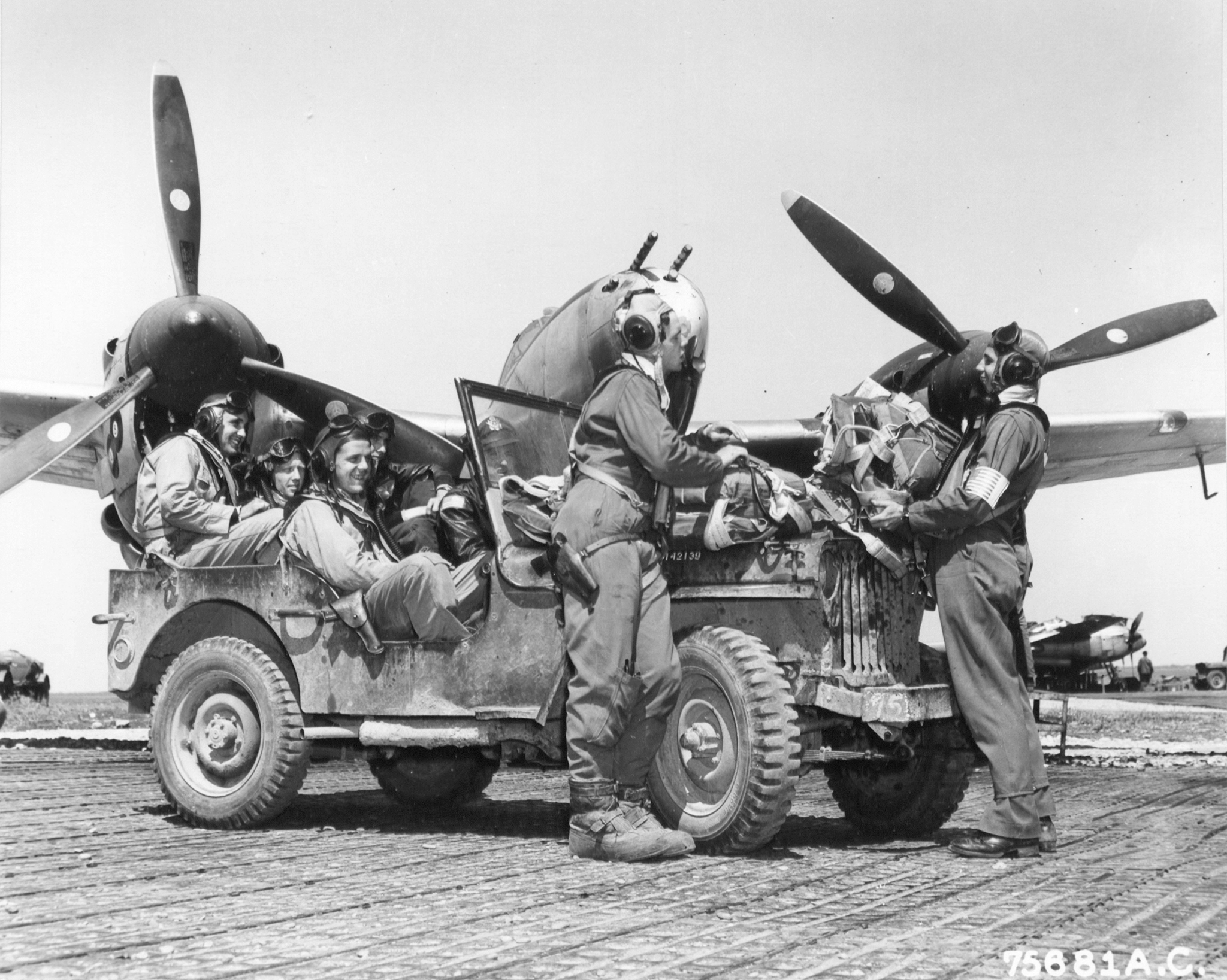 Lockheed P-38 Lightning 15AF 1FG94FS named 88 foreground as pilots return from a mission Italy 1944 01