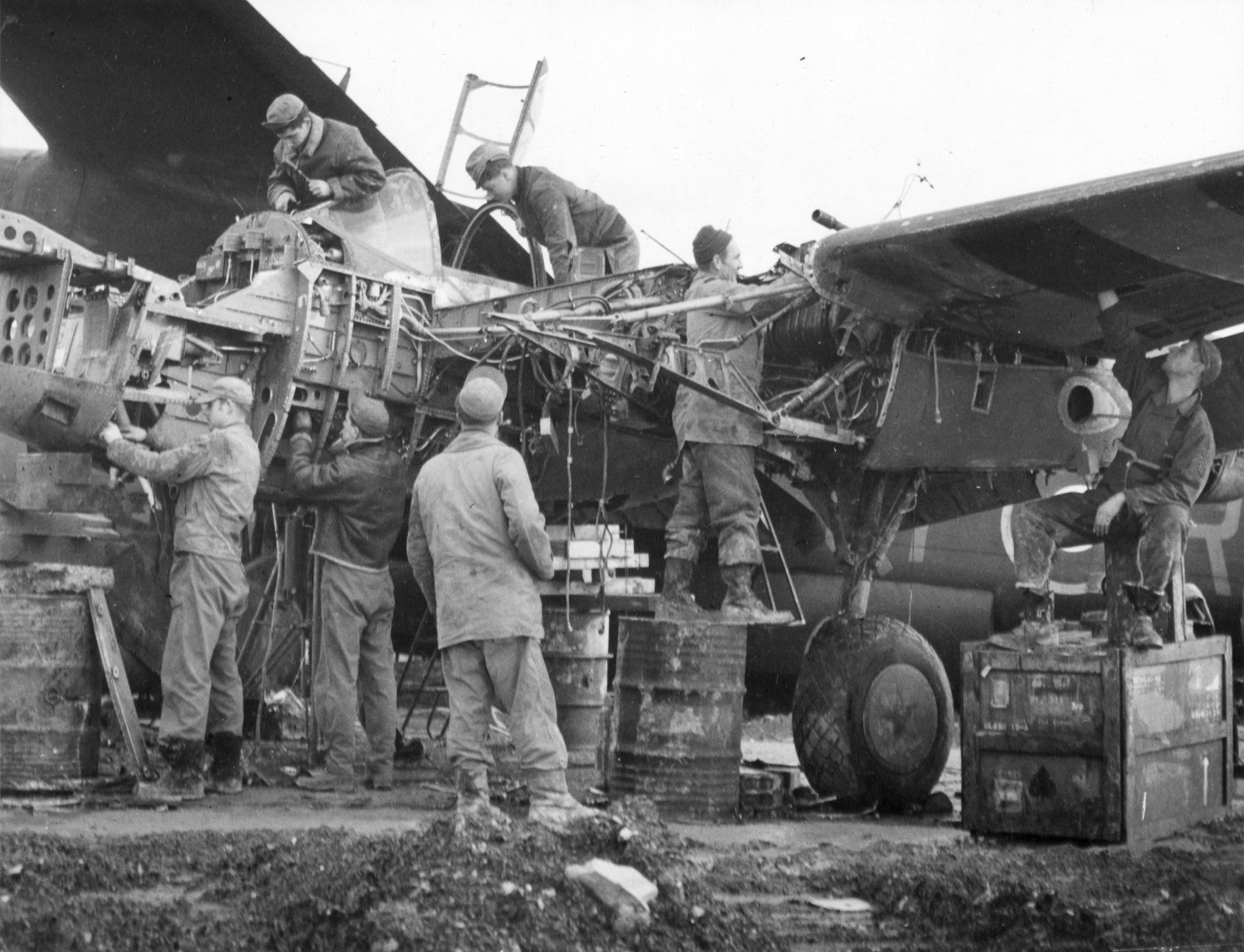 9AF Lockheed P-38 Lightning mechanics at work repairing aircraft at a forward repair depo Belgium 1944 NARA3