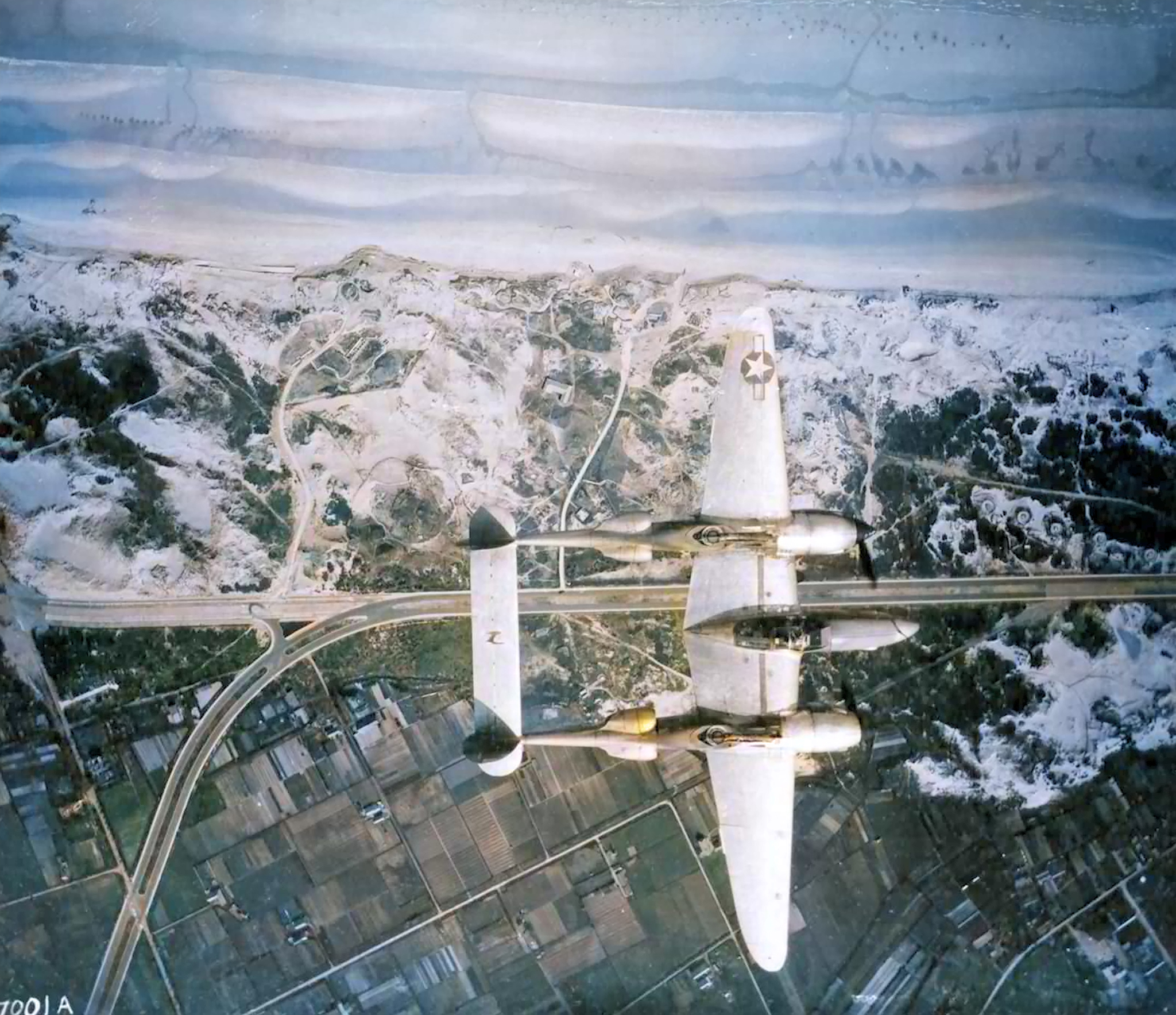 Lockheed P-38 Lightning flies over a coast line near Ostend Belgium May 1945 01
