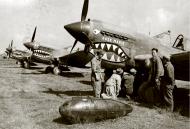 Asisbiz Curtiss P 40E Warhawk 23FG16FS named Rose Marie being refited with a drop tank 01