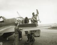 Asisbiz Curtiss P 40E Warhawk 343FG11FS Aleutian Tigers Lt James Perryman supervises loading 50 Cal ammo Aleutians 1942 NA1127