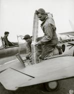 Asisbiz Curtiss P 40E Warhawk 343FG11FS Aleutian Tigers ground crew loading 50 Cal ammo Aleutian Islands 1942 NA1125