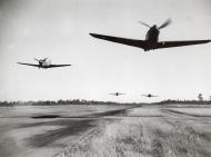 Asisbiz Curtiss P-40E Warhawk 49FG9FS White 94 Lt Robert Vaught buzzing the strip Darwin Australia 1942 04