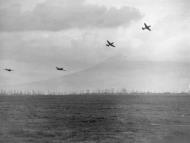 Asisbiz Curtiss P-40 Warhawks 79FG buzz the field at Capodichino and peel off for landing Italy 1944 02