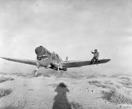 Asisbiz Curtiss Kittyhawk I RAF 112Sqn taxies through the sand at a landing ground in the Western Desert IWM CM2730