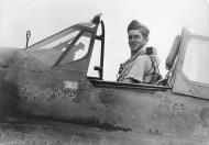 Asisbiz Aircrew RNZAF SqnLdr MJ Herrick DFC in the cockpit of his Kittyhawk at Guadalcanal 01