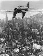 Asisbiz Seversky (an early version of the P 47D Thunderbolt) in flight over New York City May 1934 FRE9107