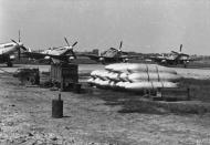 Asisbiz P 51D Mustangs 479FG434FS L2 behind stacks of fuel drop tanks at Wattisham 1945 FRE3217