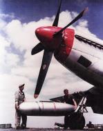 Asisbiz Crew Chiefs placing auxiliary fuel tank under wing of a P 51 Mustang at Debden 01