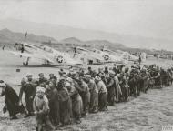 Asisbiz P 51B Mustang 14AF 23FG foreground as Chinese laborers repair the airfield at a Chinese airbase FRE10258