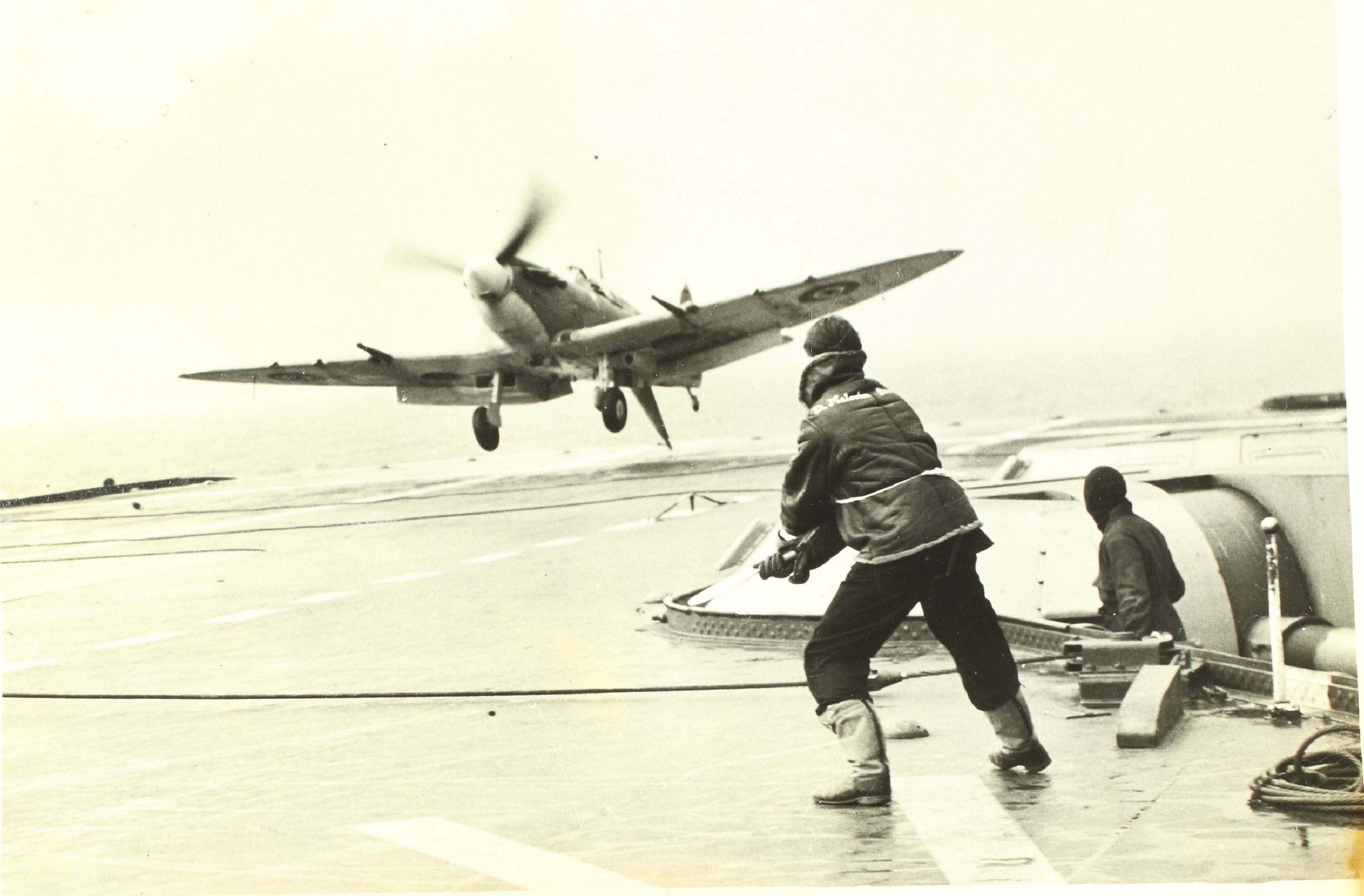 Fleet Air Arm Batsman guides Seafire HMS Indomitable 02