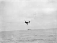 Asisbiz Fleet Air Arm Seafire from HMS Furious with the cruiser HMS Jamacia foreground Aug 1944 IWM A25079