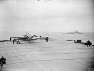 Asisbiz Fleet Air Arm Seafires aboard HMS Furious with cruiser HMS Glasgow foreground 6 9th Jul 1943 IWM A17992