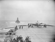 Asisbiz Fleet Air Arm Seafires aboard HMS Furious with cruiser USS South Dakota foreground 6 9th Jul 1943 IWM A17990