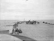 Asisbiz Fleet Air Arm Seafires aboard HMS Furious with cruiser USS South Dakota foreground 6 9th Jul 1943 IWM A17991