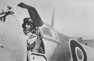 Asisbiz Aircrew French pilot sits in his aircraft waiting the go signal with improvised umbrella 01