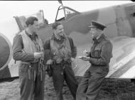 Asisbiz Aircrew RAF 91Sqn pilots FO E Topham (L) and FLt R Nash report a sortie against flying bombs to the FO C Kember at West Malling 1944 IWM